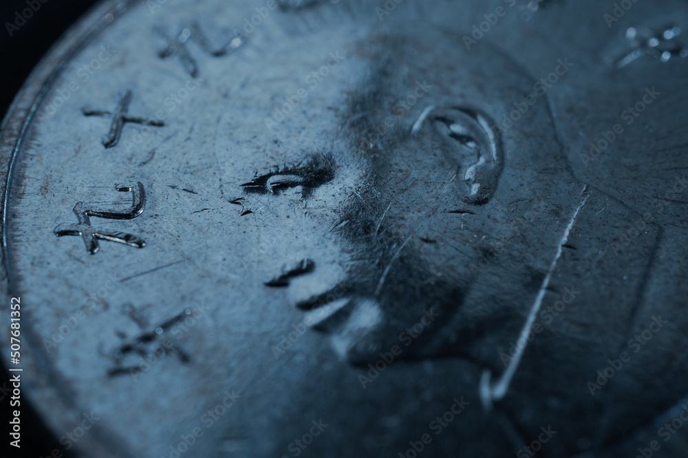 Translation: 2010. 1 one Taiwanese dollar or yuan. Taiwan money. Fragment of textured coin. Blue tinted background. Economy and banks. Dark wallpaper. News about currency or business Translation: 2010. 1 one Taiwanese dollar or yuan. Taiwan money. Fragment of textured coin. Blue tinted background. Economy and banks. Dark wallpaper. News about currency or business