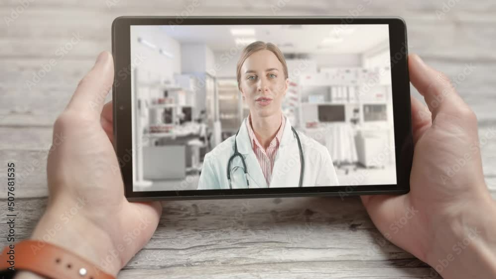 Video call with doctor while staying at home. Close up of video conferencing with general practitioner on digital tablet. Sick man or woman in online consultation. Doctor having video conference Video call with doctor while staying at home. Close up of video conferencing with general practitioner on digital tablet. Sick man or woman in online consultation. Doctor having video conference