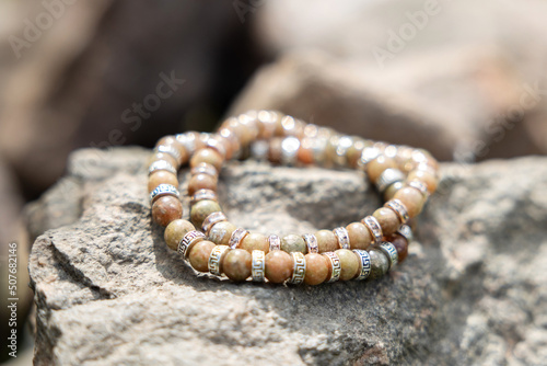 Two bracelets made of natural jasper stones beads. Handmade jewelry. Woman exoteric accessories. Talismans and amulets. Selective focus