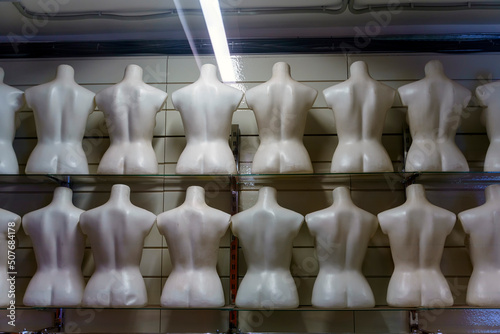 Rows of torsos from mannequins are located with their backs without clothes