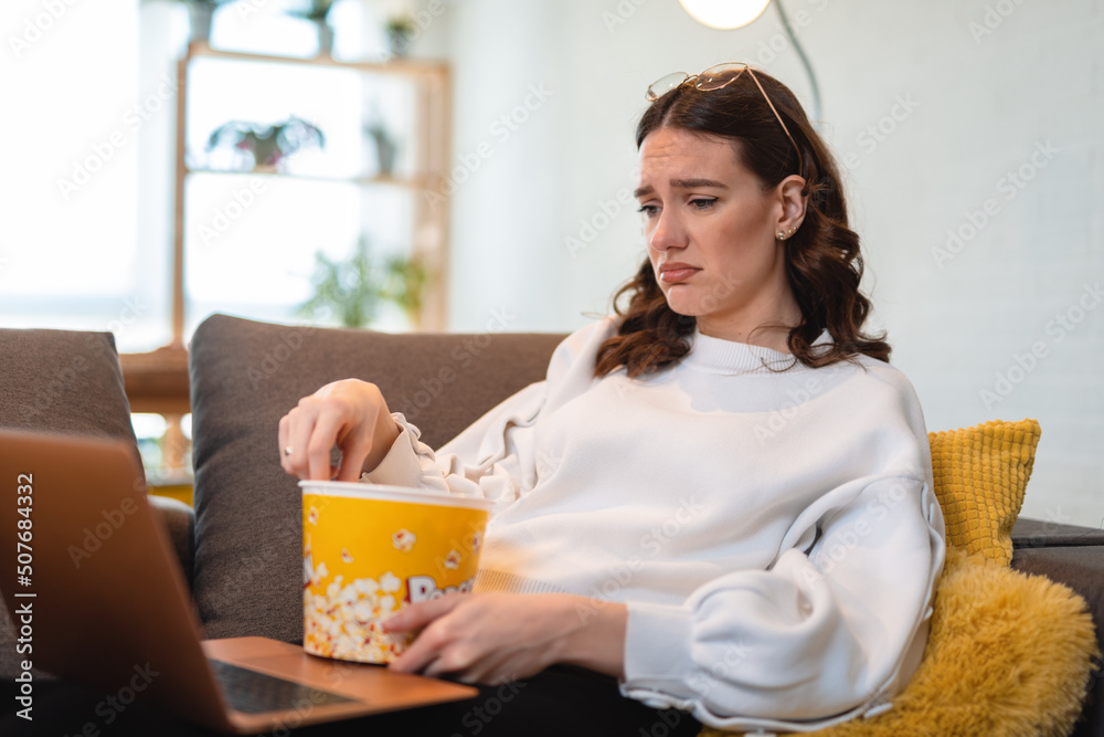 Beautiful woman watching sad movie. The woman made a sad face looking movie Beautiful woman watching sad movie. The woman made a sad face looking movie