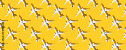 Creative composition made with passenger plane on colorful background. Summer travel or vacation pattern. Banner