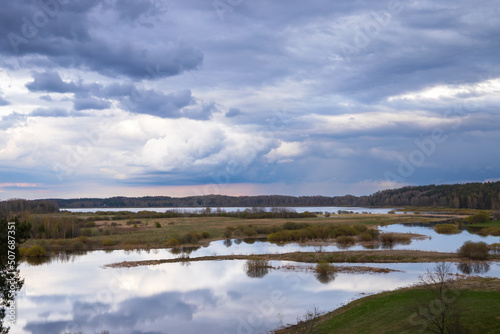 Sorot river under cloudy sky. Rural summer landscape © evannovostro