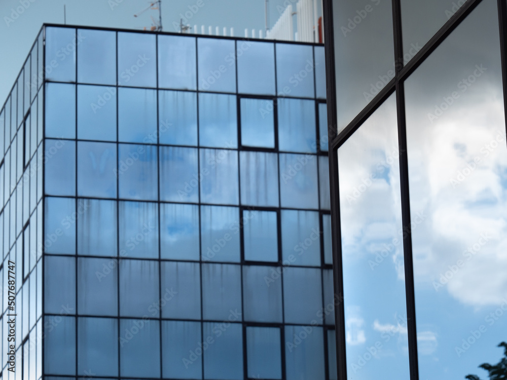 Modern Building Glass Facade Reflecting Cloudy Blue Sky Modern Building Glass Facade Reflecting Cloudy Blue Sky