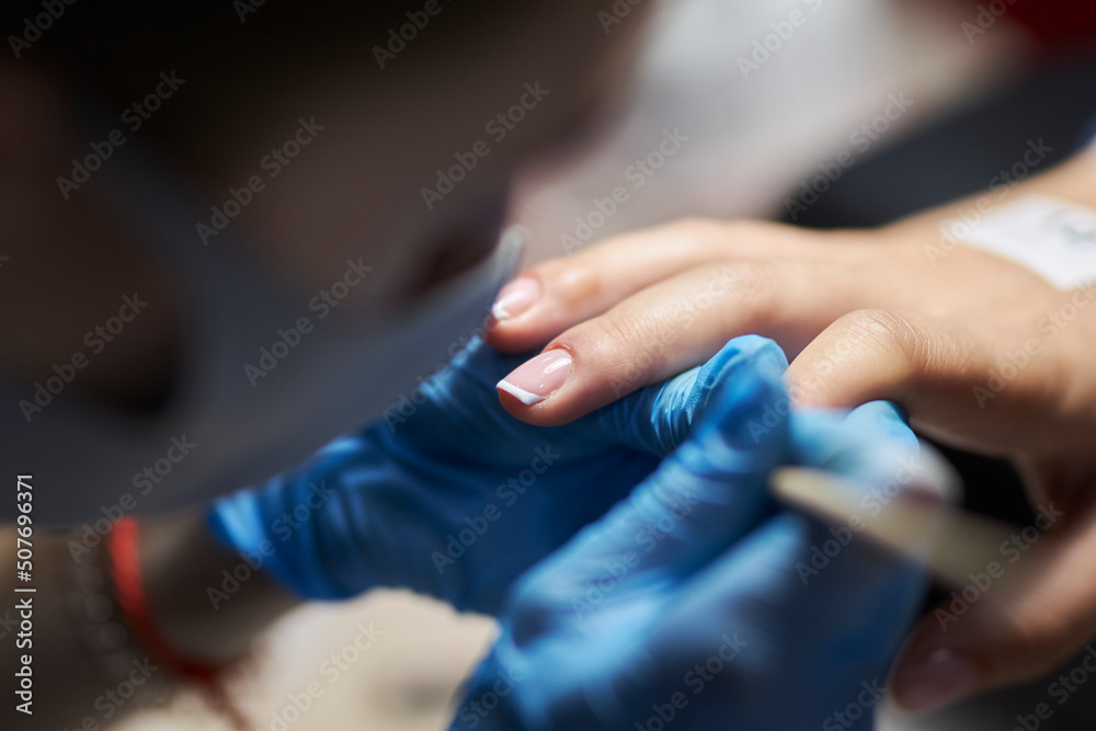 manicurist makes a manicure. The process of creating a quality manicure. Personal care. Beauty industry 
