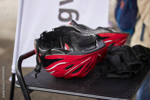 protective bicycle helmet in red color on a black table