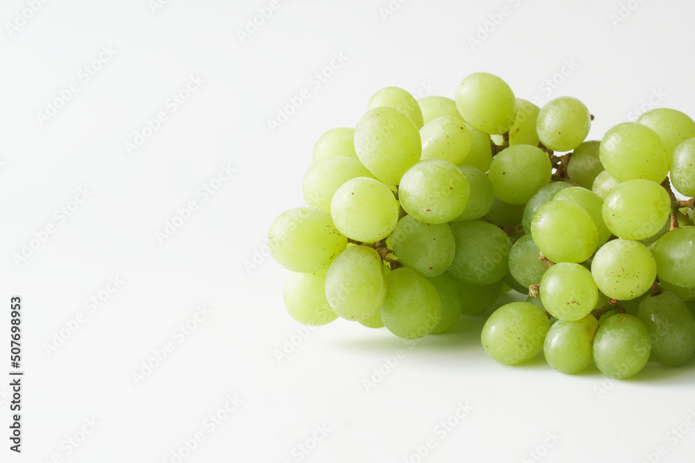 Bunch of green, white grapes on a white background. Seedless grape variety. Copy space. Bunch of green, white grapes on a white background. Seedless grape variety. Copy space.