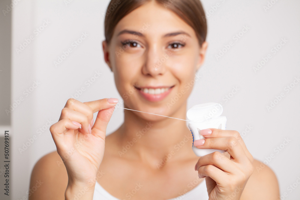 Smiling women use dental floss white healthy teeth. Smiling women use dental floss white healthy teeth.