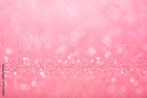 Romantic pastel pink defocused background with glitter sparkles and circle bokeh.