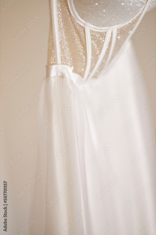 Wedding dress hanging on a trempel beautiful wedding dress 