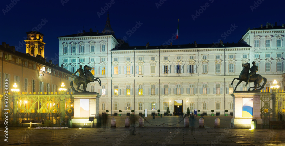 Image of Palazzo Reale illuminated at dusk at square in Turin, Italy