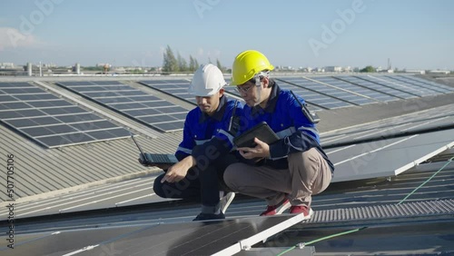 Wallpaper Mural Two Asian technician installing inspection or repair solar cell panels on background field of photovoltaic solar panels solar cells on roof top factory. Torontodigital.ca