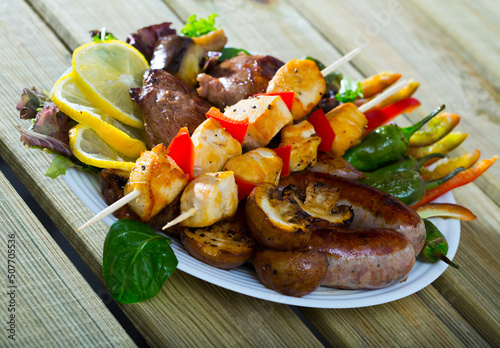Plate of dish bulgarian cuisine meshana scara with different grilled meat and vegetables photo