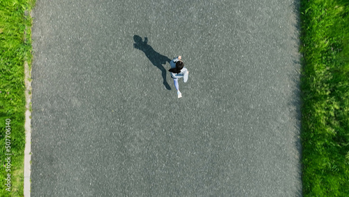Fototapeta Naklejka Na Ścianę i Meble -  土手でジョギングする女性の空撮　真俯瞰