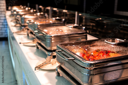 Catering buffet food with heated trays ready for service in hotel restaurant