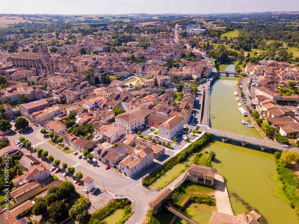 View from drone of modern cityscape of French commune of Condom on river Baise in summer