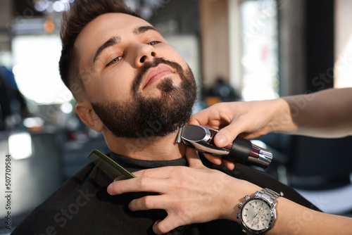 Fotografie, Obraz Professional hairdresser working with client in barbershop