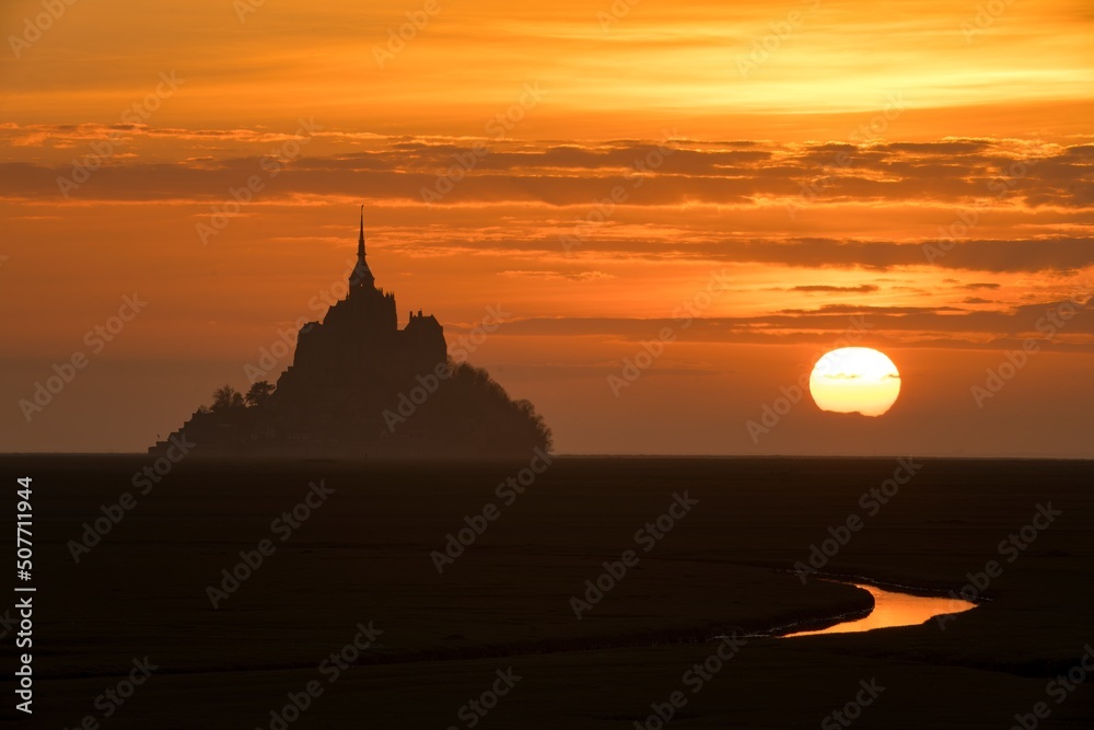 Beautiful sunset view of historic landmark Le Mont Saint-Michel in Normandy, France