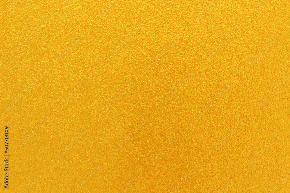 Gold or yellow paint on cement wall texture background. Stock Photo