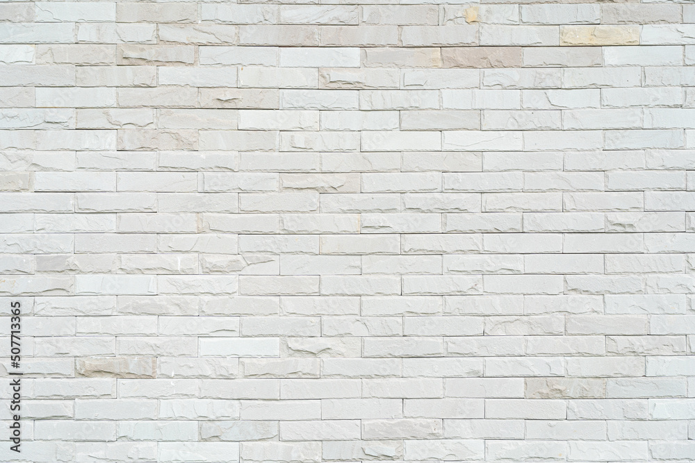 Cream and white brick wall texture background with Sunlight. Brickwork or stonework flooring interior rock old pattern clean concrete grid uneven bricks design stack. Cream and white brick wall texture background with Sunlight. Brickwork or stonework flooring interior rock old pattern clean concrete grid uneven bricks design stack.