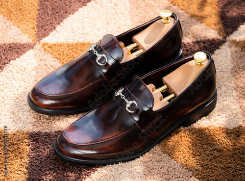 Men fashion leather brown shoes loafers on the carpet. 