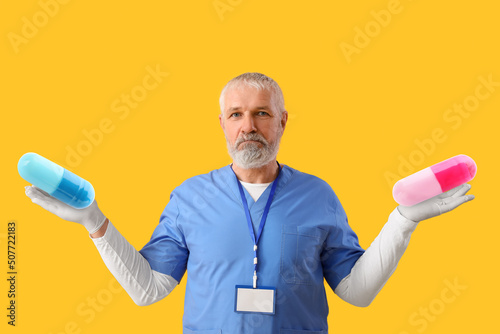 Mature male doctor with two...