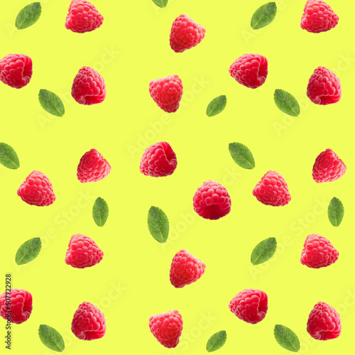 Many ripe raspberries and mint on yellow background. Pattern for design