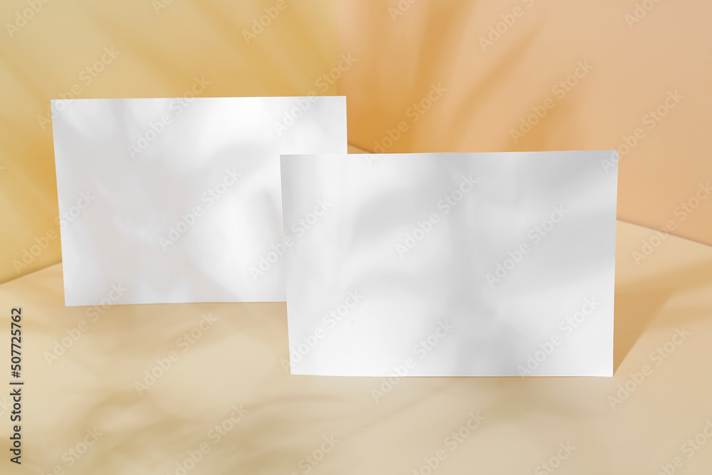 Two paper sheets with shadows on color background Two paper sheets with shadows on color background