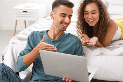 Young couple using modern l...