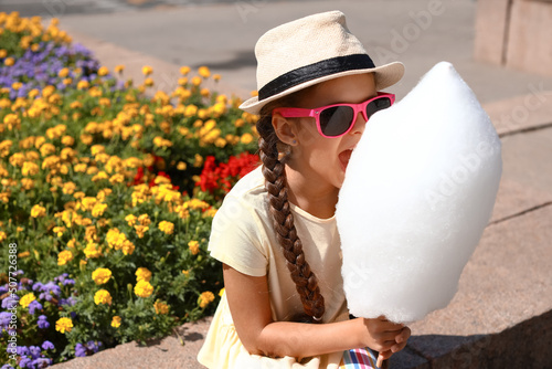 Cute little girl eating cot...