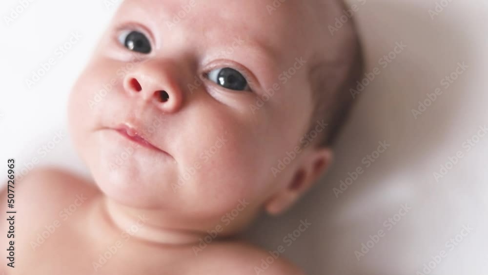 Video portrait of a baby toddler on a white background . Happy baby. A happy child. An infant looks into the camera . White background. High quality FullHD footage Video portrait of a baby toddler on a white background . Happy baby. A happy child. An infant looks into the camera . White background. High quality FullHD footage