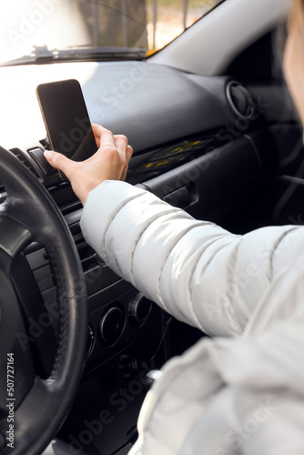 Woman using smartphone for navigation while driving car © Pixel-Shot