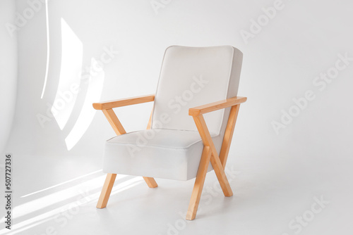Stylish wooden armchair in modern photo studio