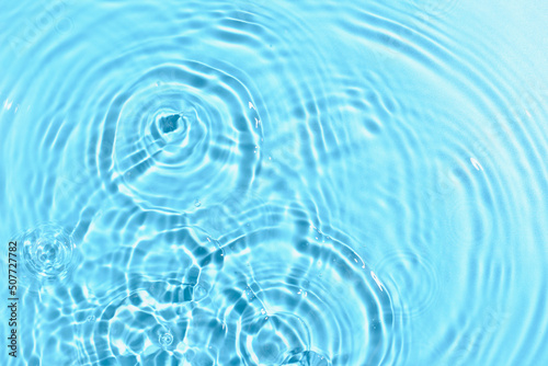 Texture of water with ripples on blue background  closeup