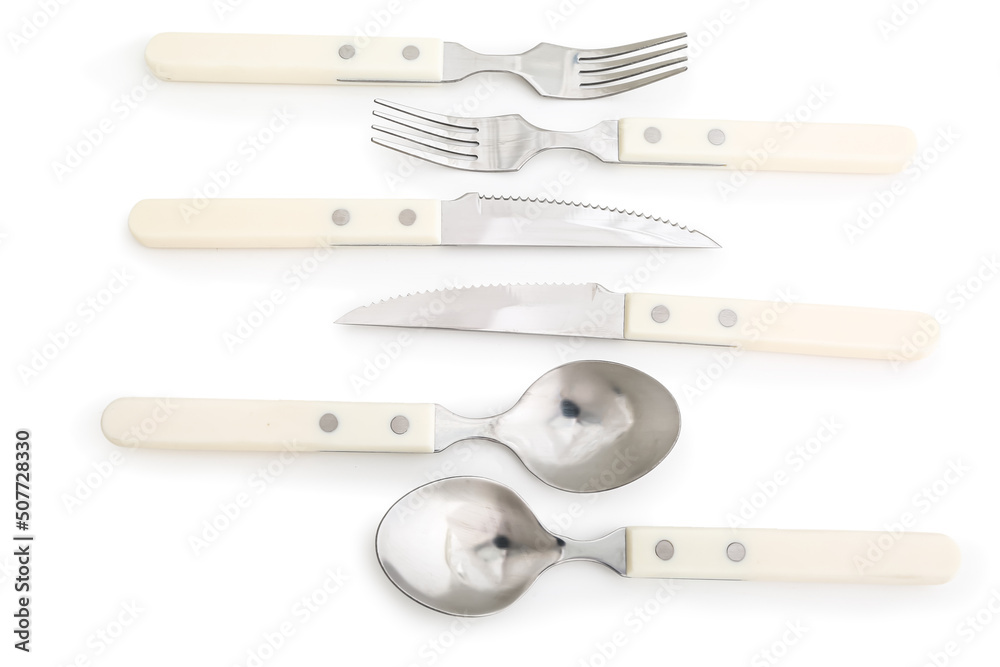 Set of stainless steel cutlery with plastic handle on white background