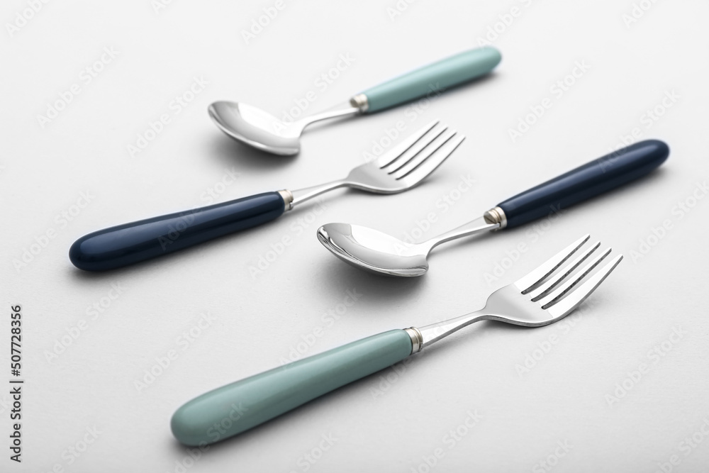 Set of stainless steel cutlery on light background Set of stainless steel cutlery on light background