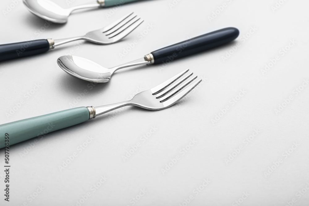 Set of stainless steel cutlery on light background, closeup Set of stainless steel cutlery on light background, closeup