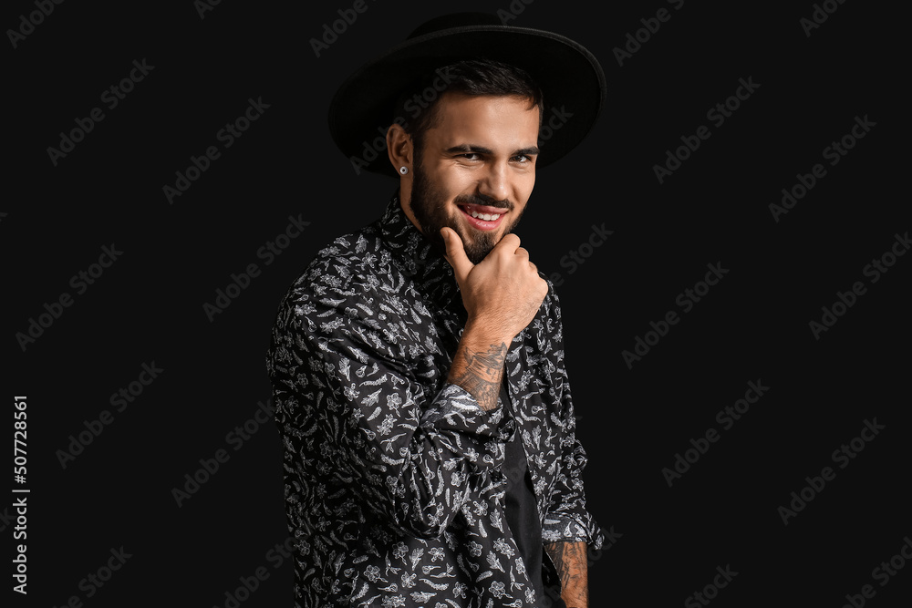 Fashionable bearded man on dark background Fashionable bearded man on dark background