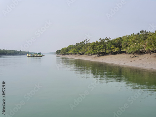 Sundarban, West Bengal, India - December 27, 2021: boat crossing the river at sundarbans national park