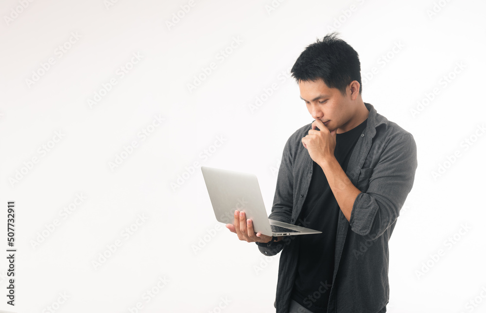 Photo of positive good young guy dressed brown cardigan typing modern device isolated white color background Photo of positive good young guy dressed brown cardigan typing modern device isolated white color background