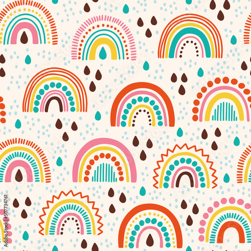 Vector seamless pattern with colored rainbows and raindrops. Bright repeated texture with hand drawn abstract doodle. Scandinavian pattern for kids clothing and wallpaper. Geometric ornament