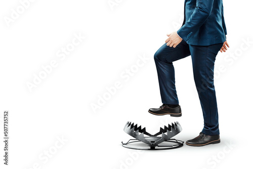 Close-up of a businessman's foot over a bear trap. The concept of problem solving, failure, crisis, crisis management, mixed media. photo