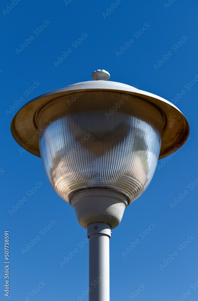 Metal street city lamp on a background of a clear sky close-up. Metal street city lamp on a background of a clear sky close-up.