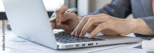 Wallpaper Mural Close-up of a woman's hand pressing on the laptop keyboard,World of technology and internet communication, Financial professionals use laptop to calculate and check real estate earnings. Torontodigital.ca