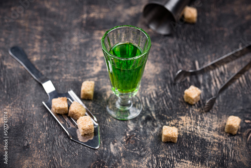 Glass of absinthe with cane sugar photo
