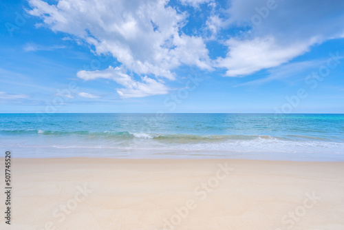 Tropical sandy beach with blue ocean and blue sky background image for nature background or summer background © panya99