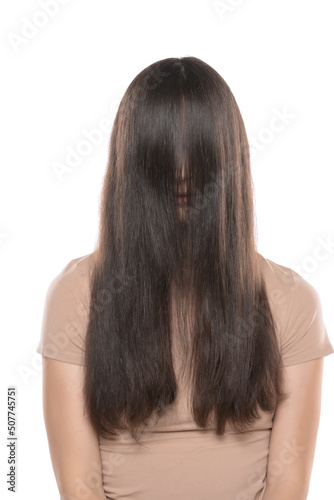 A woman with the hair over her face on a white studio background