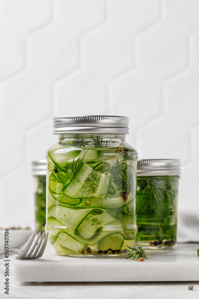 Lightly salted sliced cucumbers for the winter in jars with dill and garlic. Fermented vegetables. Lightly salted sliced cucumbers for the winter in jars with dill and garlic. Fermented vegetables.