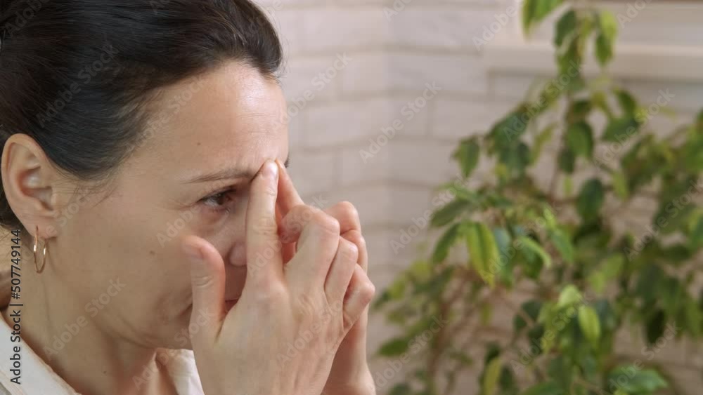 Finger massage by nose. A pretty healthy woman use finger massage on her nose for respiration in the room. Finger massage by nose. A pretty healthy woman use finger massage on her nose for respiration in the room.