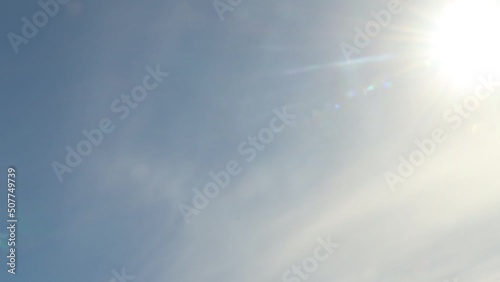 Lens flare and cumulus clouds time-lapse on a sunny day